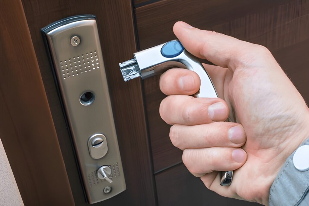 Hand using tool on door lock